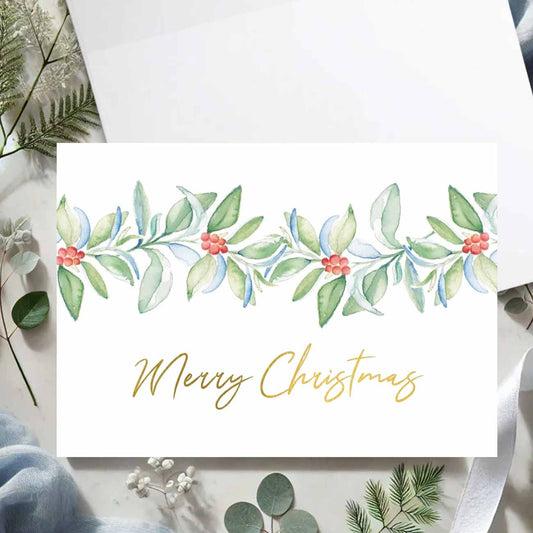 Flat lay of luxury watercolor Christmas cards featuring botanical art and the words Merry Christmas in gold foil by Victoria Grigaliunas of Do Tell A Belle a woman owned small business in South Florida