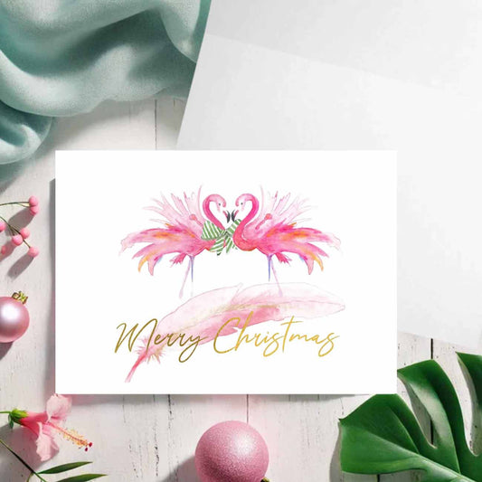 Flat lay of pink flamingo Christmas cards designed by Florida watercolor artist Victoria Grigaliunas of Do Tell A Belle a woman owned small business.