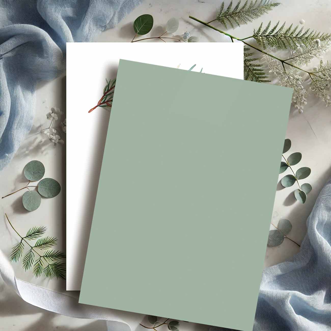 Back of green winter bridal shower invitation showing solid sage green background that complements the watercolor pine design — modern printable template from Do Tell A Belle.