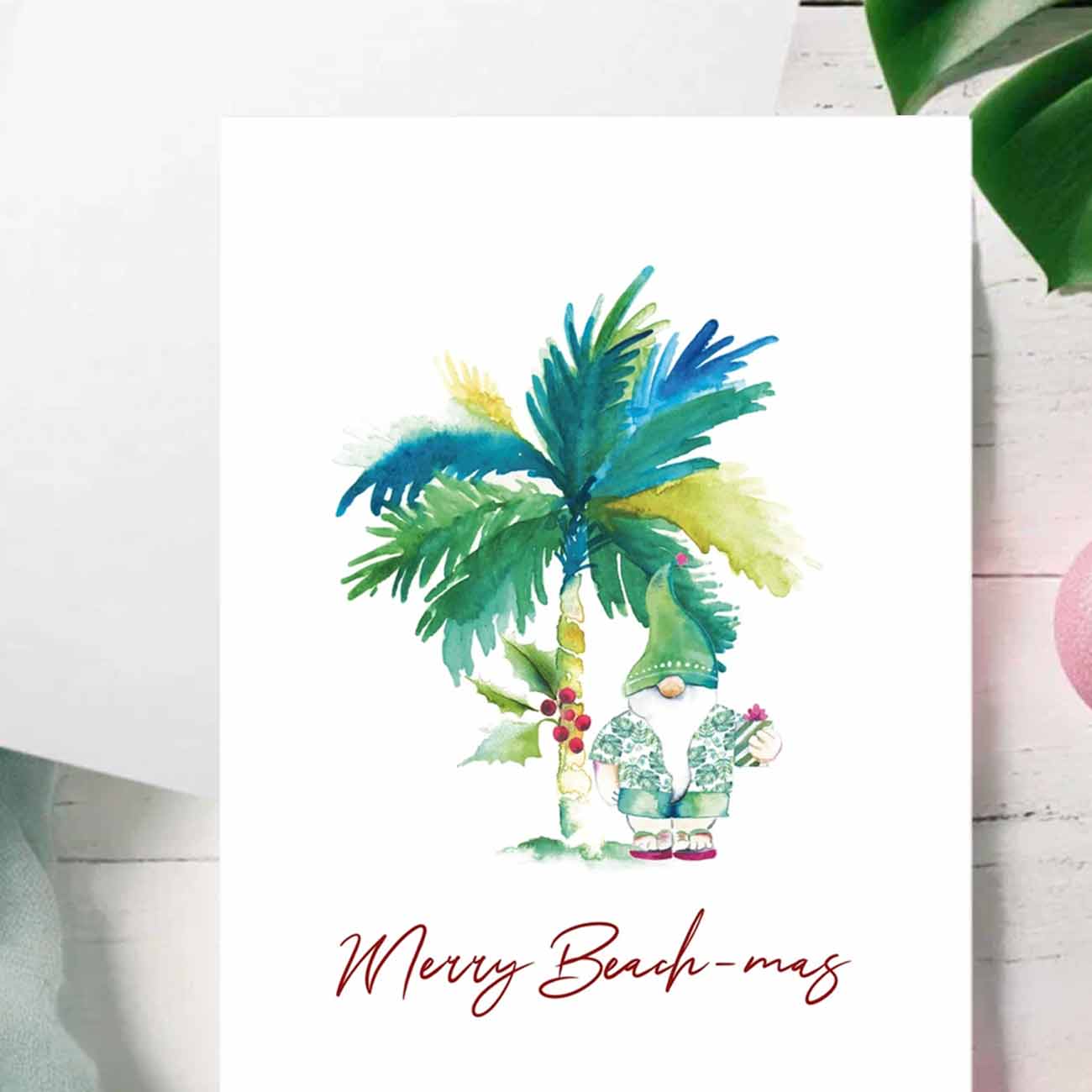 Flat lay of watercolor tropical Christmas cards with palm tree and santa clause by Do Tell A Belle a woman owned small business in South Florida.