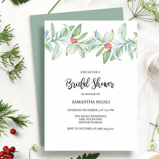Flat lay of winter bridal shower invitations template designed with water botanical art in shades of red and green on a crisp what background. Art and design by Victoria Grigaliunas of Do Tell A Belle a woman owned small business in Palm Beach Gardens Florida.