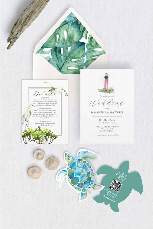 A styled flat-lay of a wedding invitation suite featuring tropical green watercolor leaves on the envelope liner, the Jupiter Lighthouse illustration on the main invitation, a bird detail on the details card, and matching sea turtle and turtle-shaped cardstock cutouts rsvp cards with qr-code on a light textured background.