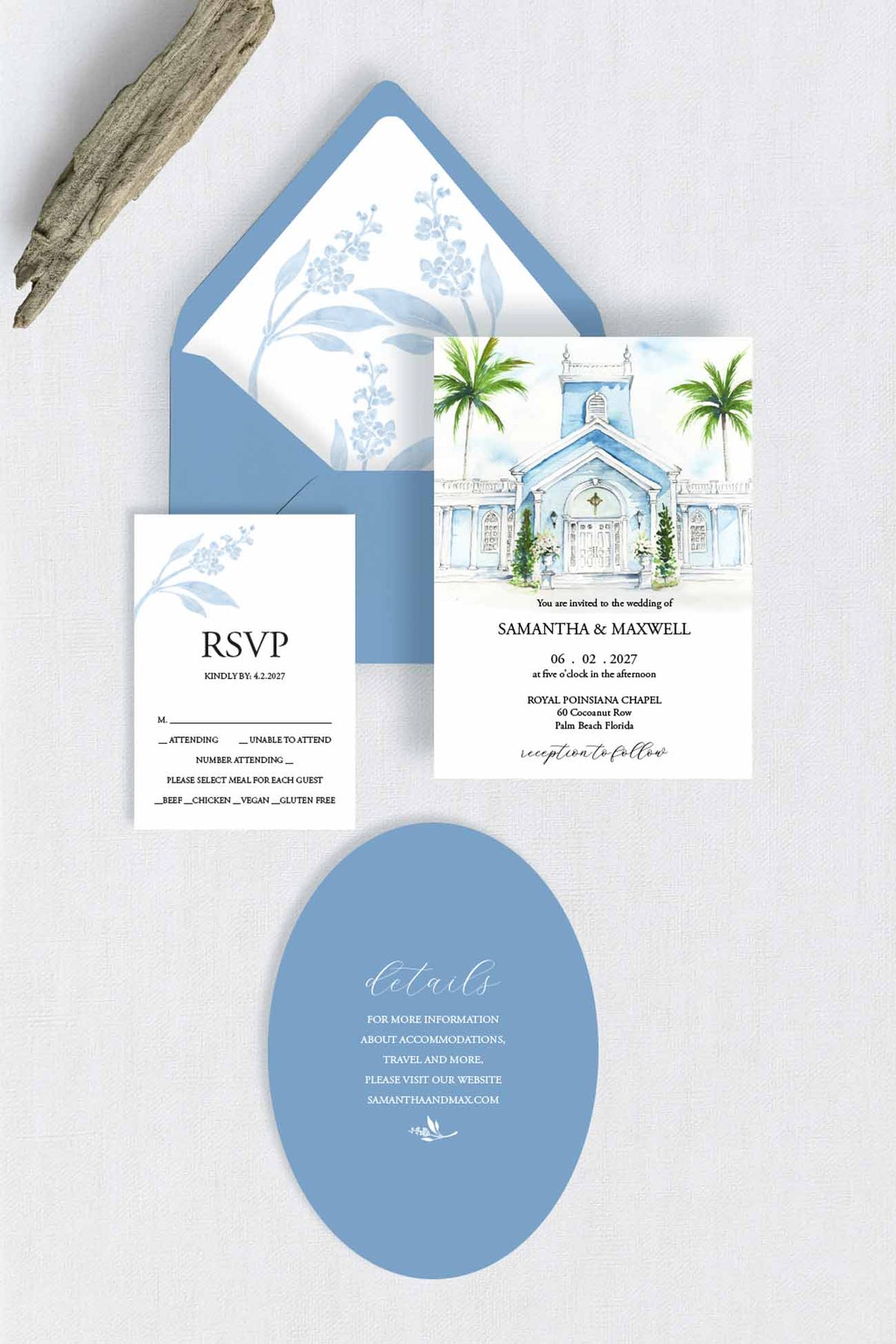 A coordinated wedding stationery set arranged on draped cream fabric, including a watercolor painting of the Royal Poinciana Chapel with palm trees invitation card with blue watercolor envelope, an RSVP card with blue floral print, a die cut blue oval details card, and a wood branch prop.