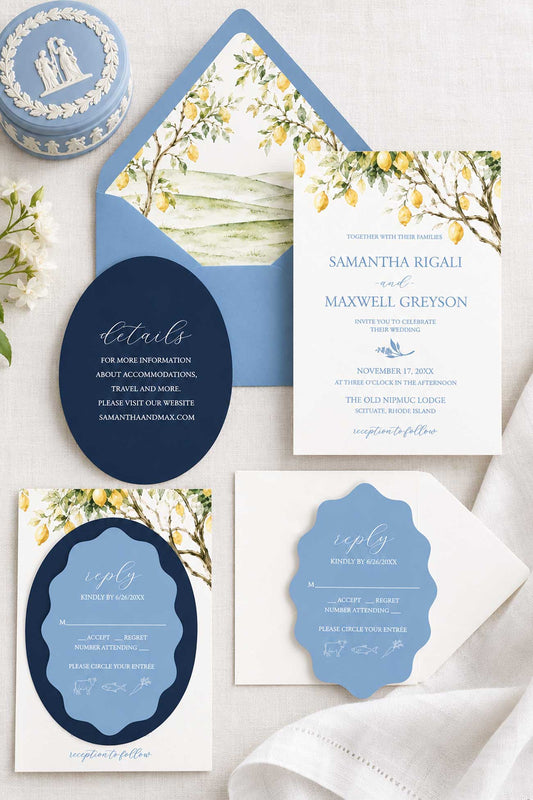 Semi-custom watercolor wedding invitations featuring a blue and yellow Tuscan wedding invitation suite with lemon trees and die cut wedding invitations. Stylized photo include a wedgwood box, botanicals and a white cloth.